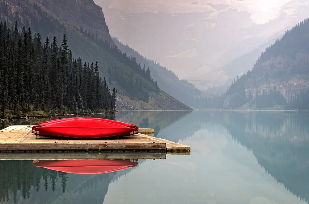 Red kayaks on a mountain lake